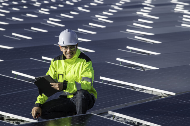 Asian engineer working floating solar power plantrenewable energytechnician investor solar panels checking panels solar energy installation